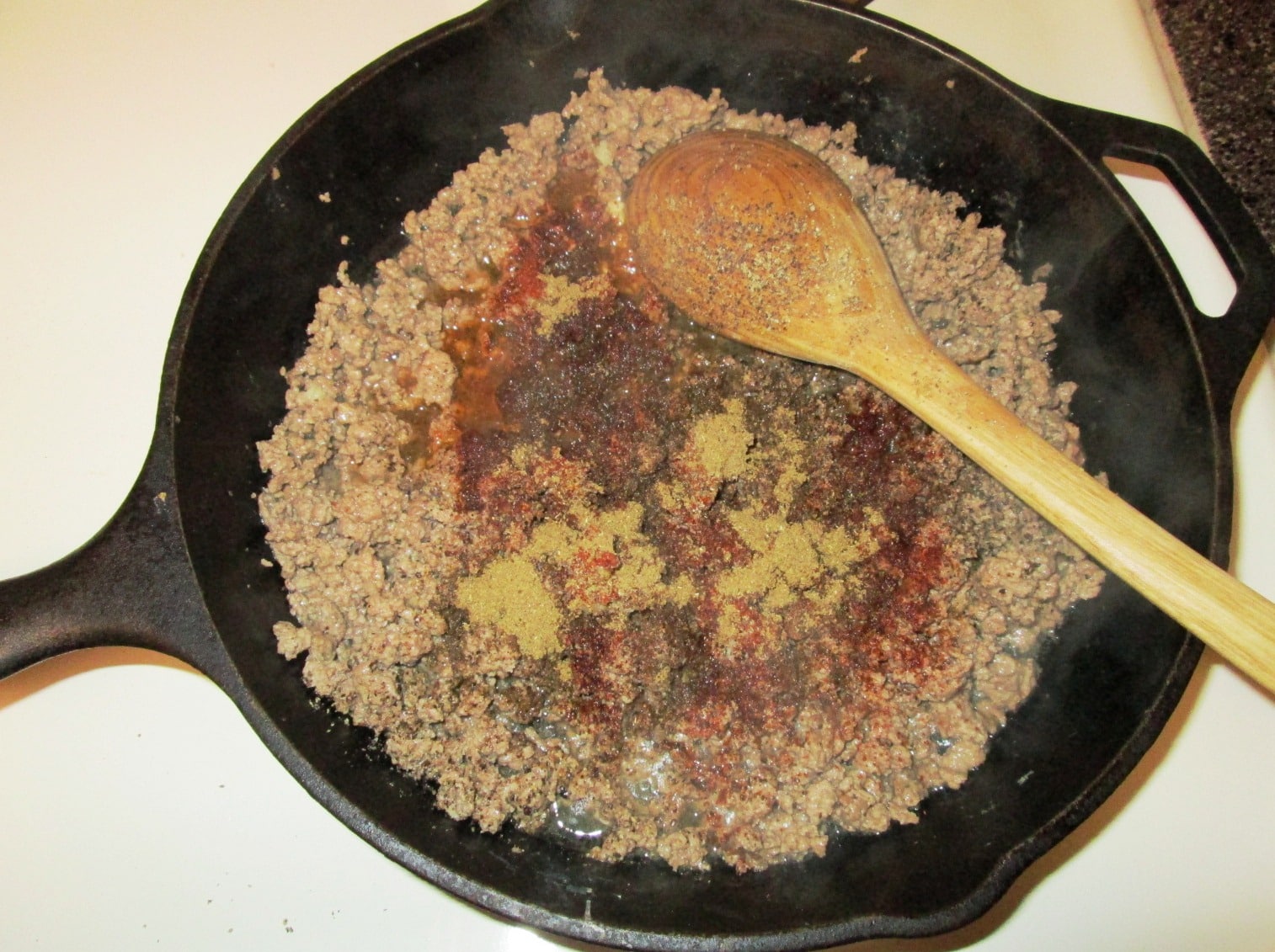 Simmering the ground beef with spices