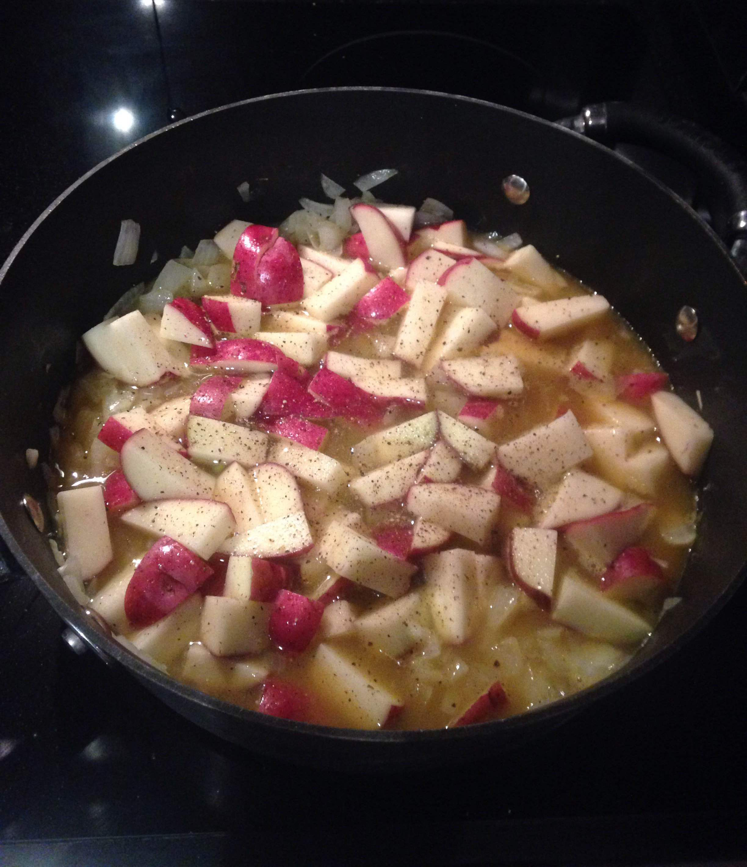 Add wine, pineapple juice, potatoes, salt and pepper.