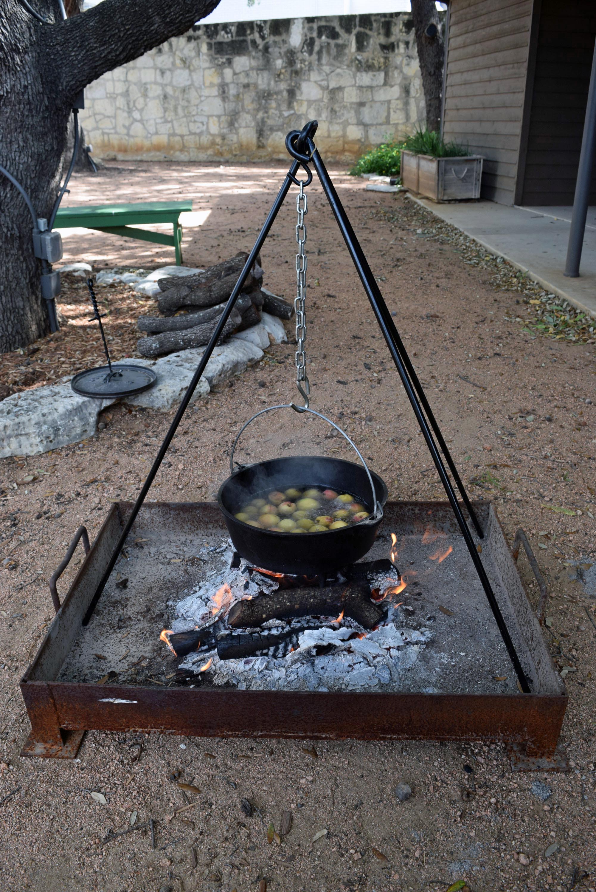 Peach sauce boiling over fire after seeds were removed.