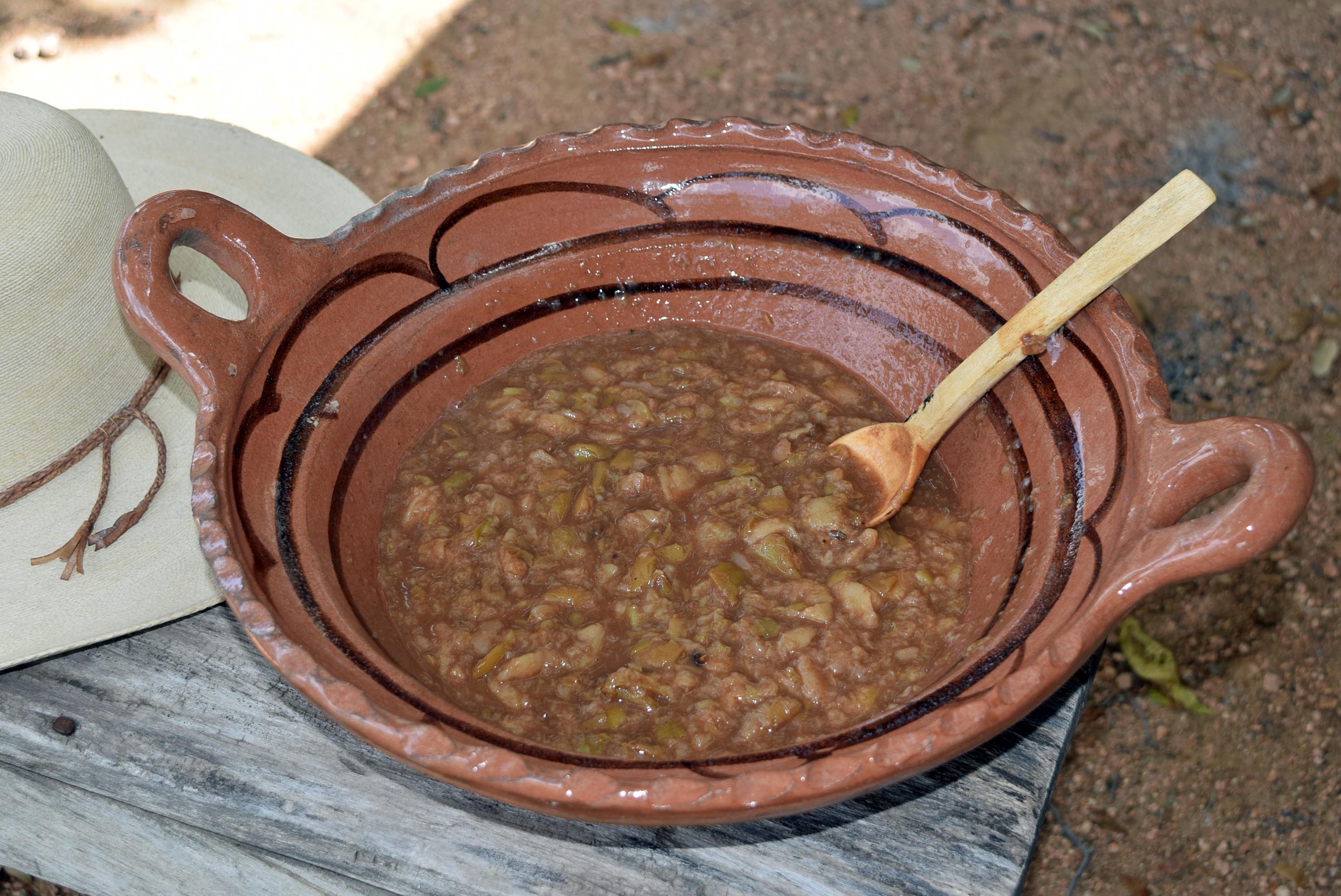 Peach sauce served in clay pot with sugar added.